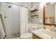 Updated bathroom featuring a modern shower, decorative shelving, and a stylish vanity at 2717 Jack Rd, Clayton, NC 27520