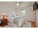 Bright bedroom featuring a ceiling fan, window, and comfortable bed with a teal throw at 2717 Jack Rd, Clayton, NC 27520