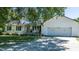 Charming home featuring a two-car garage, classic white siding, and a well-manicured front yard at 2717 Jack Rd, Clayton, NC 27520