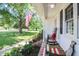 Charming front porch adorned with a rocking chair, American flag, and lush landscaping at 2717 Jack Rd, Clayton, NC 27520