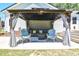 Relaxing gazebo featuring comfortable seating and a charming outdoor living space with string lights and curtains at 2717 Jack Rd, Clayton, NC 27520