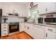 Charming kitchen with white cabinetry, granite countertops, stainless steel appliances, hardwood floors and ample natural light at 2717 Jack Rd, Clayton, NC 27520