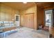 View of the spacious living room with wood paneled walls, neutral tones, and access to an adjacent room at 2717 Jack Rd, Clayton, NC 27520