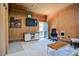 View of the spacious living room with wood paneled walls, sleek entertainment center, and modern décor at 2717 Jack Rd, Clayton, NC 27520