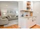 Inviting living room featuring a comfortable sofa and stylish decor, flowing into the kitchen area with custom cabinets at 2717 Jack Rd, Clayton, NC 27520