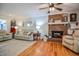 Bright living room with hardwood floors, a brick fireplace, comfortable seating, and stylish decor at 2717 Jack Rd, Clayton, NC 27520