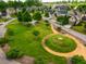 This aerial view showcases the circle-themed common area with walking paths and mature trees at 281 N Serenity Hill Cir, Chapel Hill, NC 27516