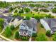 Aerial view of a blue home in a community with lush greenery, tree-lined streets, and a central park at 281 N Serenity Hill Cir, Chapel Hill, NC 27516