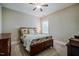 Bedroom with ceiling fan, carpet and a wooden bed frame and colorful floral comforter at 281 N Serenity Hill Cir, Chapel Hill, NC 27516