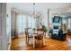 Charming dining room with hardwood floors, chandelier lighting, and large windows at 281 N Serenity Hill Cir, Chapel Hill, NC 27516