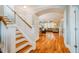 Inviting foyer with hardwood floors and staircase leading to upper level and arched entrance to the living room at 281 N Serenity Hill Cir, Chapel Hill, NC 27516