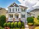 Charming two-story home featuring a covered front porch with stone accents and a landscaped front yard at 281 N Serenity Hill Cir, Chapel Hill, NC 27516