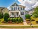 Charming two-story home with a welcoming front porch, beautiful landscaping, and a well-manicured lawn at 281 N Serenity Hill Cir, Chapel Hill, NC 27516