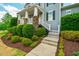 Beautifully landscaped front of the home with stone pillars, white railing, and a well-maintained walkway at 281 N Serenity Hill Cir, Chapel Hill, NC 27516