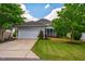 Charming home with a two-car garage, covered porch, grass lawn, and mature trees at 281 N Serenity Hill Cir, Chapel Hill, NC 27516