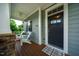 Charming front porch featuring a ceiling fan, wood flooring, Adirondack chairs, and a welcoming front door at 281 N Serenity Hill Cir, Chapel Hill, NC 27516