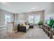 Cozy living room with neutral carpet, comfortable seating, and bright windows at 281 N Serenity Hill Cir, Chapel Hill, NC 27516