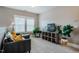 Comfortable living room with carpet, a gray sofa, a television, and a sewing table at 281 N Serenity Hill Cir, Chapel Hill, NC 27516