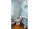 Charming powder room with a pedestal sink, wood floors, a window, and decorative shelving at 281 N Serenity Hill Cir, Chapel Hill, NC 27516