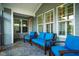 This screened porch features outdoor seating, gray siding, and backyard views at 281 N Serenity Hill Cir, Chapel Hill, NC 27516