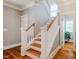 Staircase with hardwood steps and white railings at 281 N Serenity Hill Cir, Chapel Hill, NC 27516