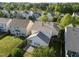 Aerial backyard view showcasing lush grass, stone patio, and screened-in porch at 2812 Prospect Pkwy, Durham, NC 27703