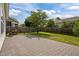 Beautiful backyard featuring a stone patio, a tree, lush grass and a swing set at 2812 Prospect Pkwy, Durham, NC 27703