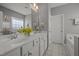 Bathroom with double sink vanity, white cabinets, large mirror, and stylish fixtures at 2812 Prospect Pkwy, Durham, NC 27703