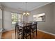 Dining room with hardwood floors, a chandelier, and large window offering natural light at 2812 Prospect Pkwy, Durham, NC 27703