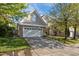 Charming two-story home showcasing stone accents, a wide driveway and a green lawn at 2812 Prospect Pkwy, Durham, NC 27703