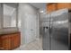 Spacious kitchen features stainless steel refrigerator, wood cabinets, and tile flooring at 2812 Prospect Pkwy, Durham, NC 27703