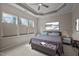 Relaxing main bedroom featuring a tray ceiling, three large windows, and neutral tones at 2812 Prospect Pkwy, Durham, NC 27703