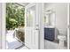 Bathroom with blue vanity visible through an open door, toilet, mirror, vanity, and gray tile floors at 30 Ocoee Falls Dr, Chapel Hill, NC 27517