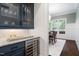 Butlers pantry with custom blue cabinetry, wine fridge and marble countertop at 30 Ocoee Falls Dr, Chapel Hill, NC 27517