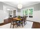 Formal dining room with large windows, decorative rug, and elegant chandelier at 30 Ocoee Falls Dr, Chapel Hill, NC 27517