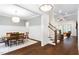 Open-concept dining room next to living room with coffered ceiling and hardwood floors at 30 Ocoee Falls Dr, Chapel Hill, NC 27517