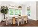 Elegant dining room with large windows, modern light fixture, and comfortable seating at 30 Ocoee Falls Dr, Chapel Hill, NC 27517