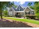 Charming two-story home with stone and shingle siding, manicured lawn, and inviting front porch at 30 Ocoee Falls Dr, Chapel Hill, NC 27517