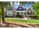 Charming two-story home with stone and shingle siding, manicured lawn, and inviting front porch at 30 Ocoee Falls Dr, Chapel Hill, NC 27517