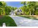 Well-manicured lawn, long driveway leading to the 2 car garage and a beautiful home with stone accents at 30 Ocoee Falls Dr, Chapel Hill, NC 27517