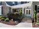 Inviting front porch with stone accents, double doors, and manicured landscaping at 30 Ocoee Falls Dr, Chapel Hill, NC 27517
