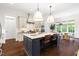 Bright kitchen features a large island with seating, stainless appliances, and hardwood floors at 30 Ocoee Falls Dr, Chapel Hill, NC 27517