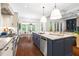 Gourmet kitchen with island, stainless appliances, and adjacent breakfast nook and living area at 30 Ocoee Falls Dr, Chapel Hill, NC 27517