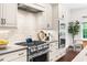 Well-appointed kitchen with stainless steel range, white cabinets, and tile backsplash at 30 Ocoee Falls Dr, Chapel Hill, NC 27517