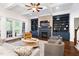 Bright living room featuring custom built-ins, fireplace, and hardwood floors at 30 Ocoee Falls Dr, Chapel Hill, NC 27517