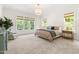 Spacious main bedroom with carpet, three large windows, and decorative lighting at 30 Ocoee Falls Dr, Chapel Hill, NC 27517