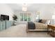 Bright main bedroom with a sitting area, large windows, and neutral decor at 30 Ocoee Falls Dr, Chapel Hill, NC 27517