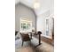 Bright home office with a large window, modern desk, stylish chair, and vaulted ceiling at 30 Ocoee Falls Dr, Chapel Hill, NC 27517