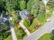 Aerial view of a well maintained home surrounded by lush greenery, landscaping, and mature trees at 300 Livingstone Dr, Cary, NC 27513