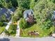 Aerial view of a home showcasing the well-maintained lawn, landscaped garden beds and mature trees at 300 Livingstone Dr, Cary, NC 27513